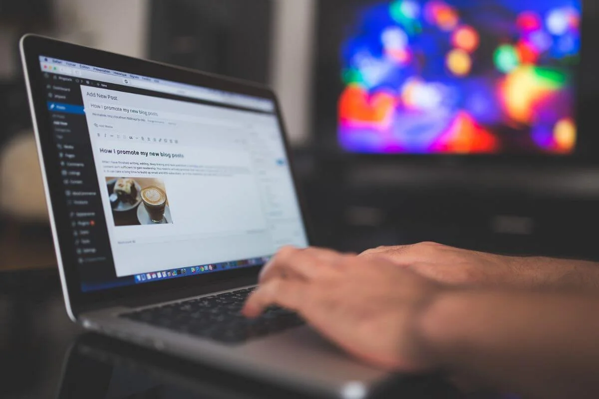 Person editing and publishing a blog post on a laptop, representing content creation and digital marketing for travel brands.