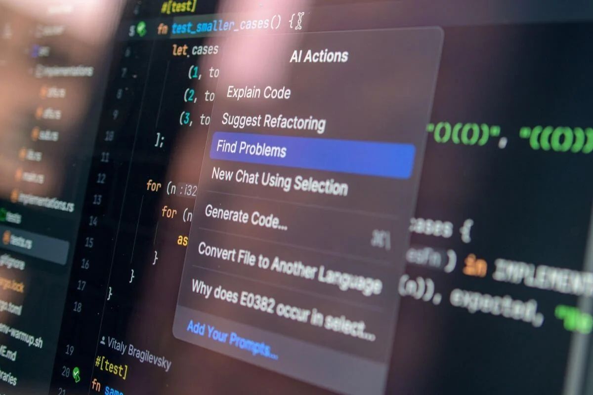  Close-up of a computer screen showing source code with an AI actions menu open, highlighting options like explaining code, finding problems, and suggesting refactoring.